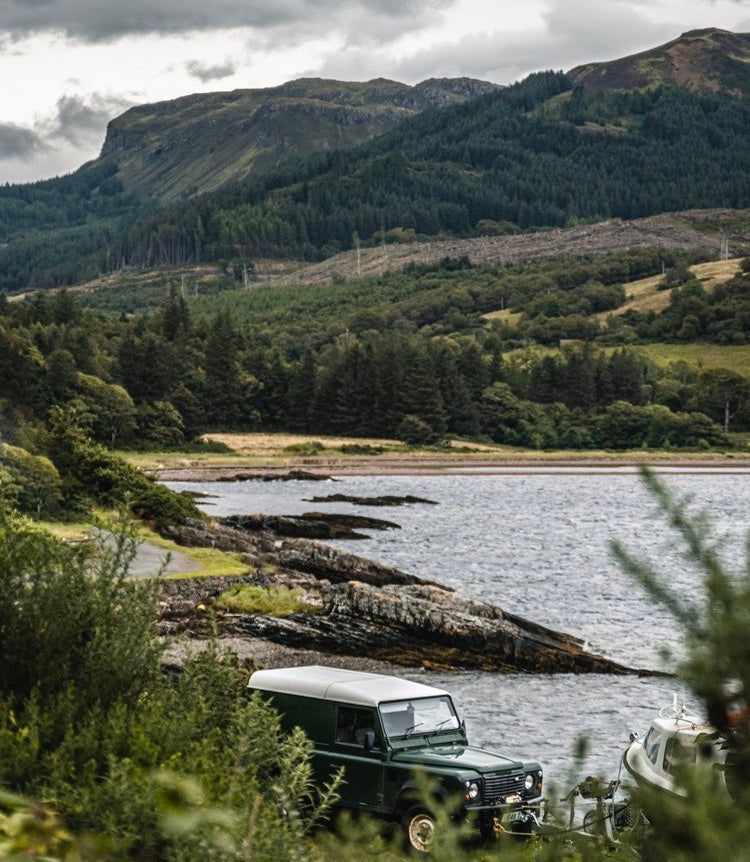 Land Rover Driving Beside a River