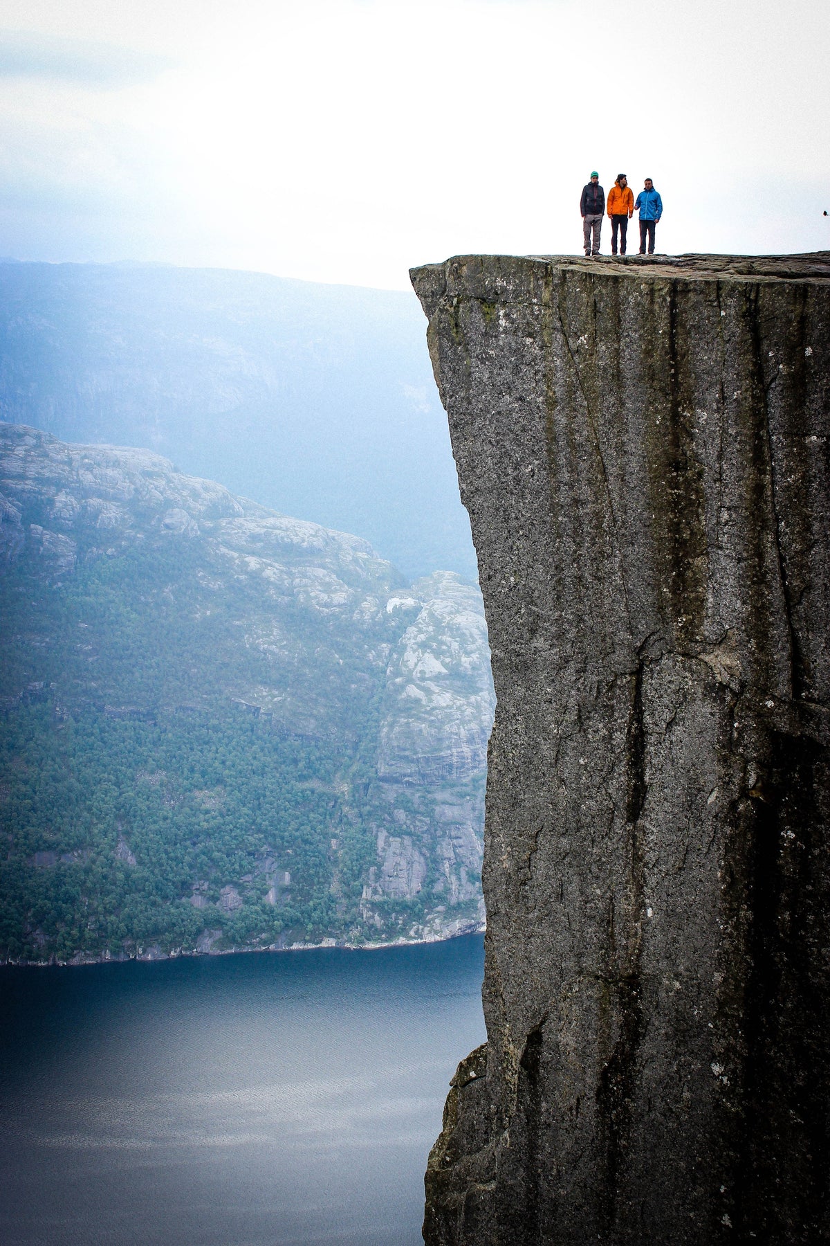 Three men on a cliff edge